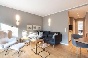 a living room with a couch and a table at Ferienwohnung Deck7 in Borkum