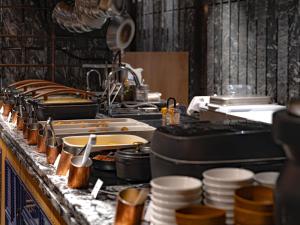 a kitchen with many pots and pans on a counter at Mercure Kyoto Station in Kyoto +202 photos