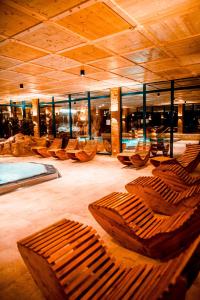 a room with a bunch of wooden chairs in a building at Spa Camping Schwarzwälder Hof in Seelbach