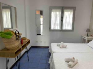 a bedroom with two beds and a basket on the floor at Numancia 1 - 4A in Las Palmas de Gran Canaria