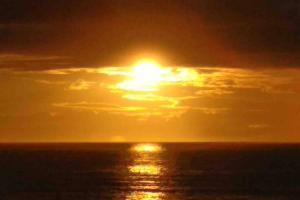 a sunset over the ocean with the sun in the sky at Numancia 1 - 4A in Las Palmas de Gran Canaria
