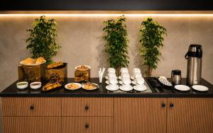 a table with plates of food on a counter at Alaya Stays Luxora Suites, Golf Course Rd near galleria in Gurgaon