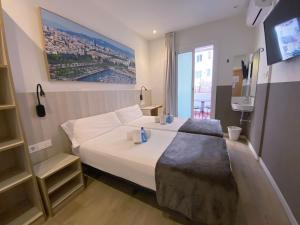 a hotel room with a bed and a tv at Hostal BESTPRICE Barcelona Stadium in Barcelona +40 photos