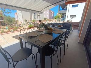 a table and chairs on an outdoor patio at PaCha Boutique house in Novalja +108 photos