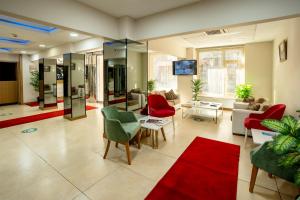 a living room with red and green chairs at La Garden Hotel Old City in Istanbul