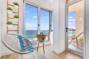 a room with a chair and a view of the ocean at Numancia 1-4B in Las Palmas de Gran Canaria