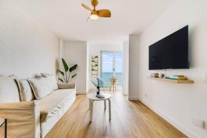 a living room with a couch and a tv at Numancia 1-4B in Las Palmas de Gran Canaria