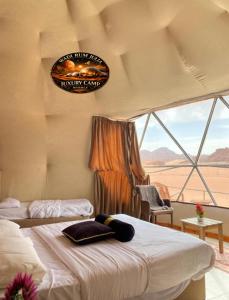 a bedroom with two beds and a view of the desert at WADI RUM JULIA lUXURY CAMP in Wadi Rum