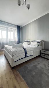 a bedroom with a large white bed in a room at Алматушечка in Almaty