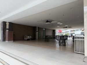 an empty lobby with tables and chairs on a building at 2BR Unit at Hill Residences I Free Parking in Manila