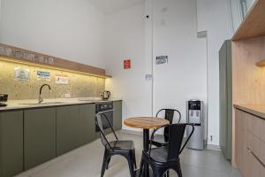 a kitchen with a table and chairs and a sink at Casa Lima Sur in Buenos Aires