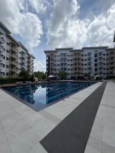 a swimming pool in front of some apartment buildings at 2BR Unit at Hill Residences I Free Parking in Manila