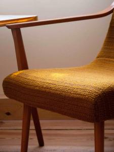 a wooden chair sitting next to a table at Das Wilde 70er in Dobritz