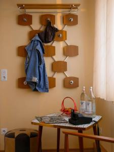 a room with a table with a jacket hanging on a wall at Das Wilde 70er in Dobritz