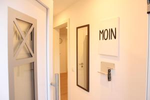 a door to a room with a mirror and a door to a hallway at Ferienwohnung "Lüttje Koje" in Barßel