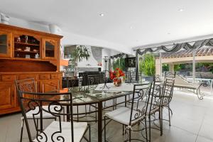 a dining room with a glass table and chairs at Maison avec piscine Soleil d'Azur in Fréjus