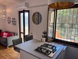 a kitchen with a stove top oven in a room at Casa Merella in Narbolia