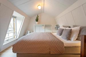 a bedroom with a bed and a window at Huisje De Koning in Zandvoort