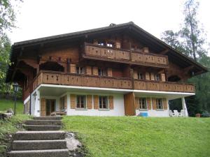 a large building with stairs in front of it at Chalet Castor in Les Diablerets