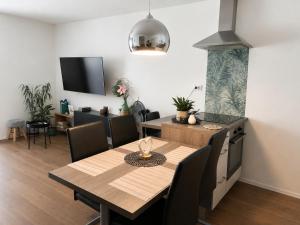 a kitchen and dining room with a table and chairs at Apartma Lilly in Bohinjska Bela