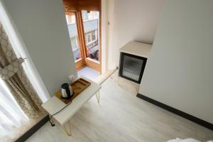 a living room with a fireplace and a tv at Şiva Pera Hotel & Spa in Istanbul