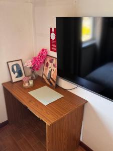 a wooden table with a television on top of it at The Travellers Den in Matosinhos +15 photos