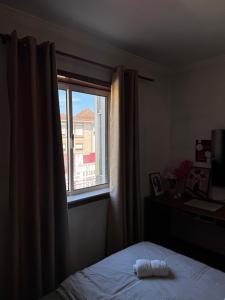 a bedroom with a bed and a window at The Travellers Den in Matosinhos