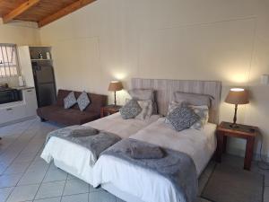 a bedroom with a large bed and a couch at Lyn's Self Catering in Swakopmund