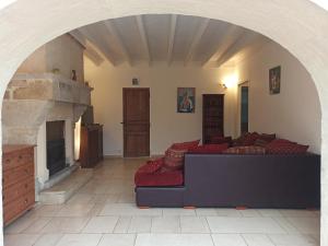a living room with a couch and a fireplace at Maison de charme en pierre in Morville