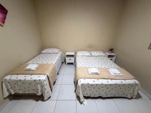 a room with two beds and a tiled floor at Casa mobiliada AR01 com 5 camas e 2 quartos in Juazeiro do Norte +25 photos