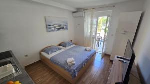 a bedroom with a bed and a television in it at Apartmani Darijo in Čelina +98 photos