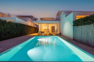 a swimming pool in front of a house at Villa D'Argento in Ragusa