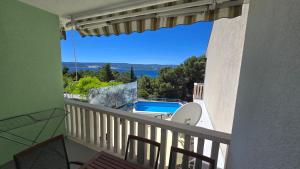 a balcony with a view of a swimming pool at Apartmani Darijo in Čelina