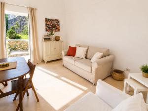 a living room with a couch and a table at Maridea - Villa Alta Marea in Ponza