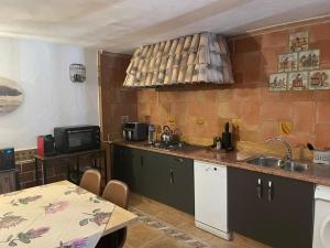 a kitchen with a sink and a table at Guest Wing at Casa Africa in Lorca +22 photos