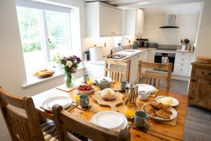 a kitchen with a wooden table with food on it at Grimsbury Castle in Thatcham