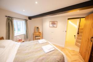a bedroom with a large bed with two towels on it at Grimsbury Castle in Thatcham +20 photos