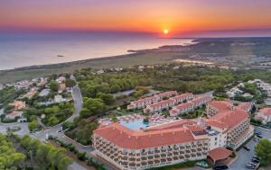 an aerial view of a resort with a sunset at Valentin Son Bou in Son Bou