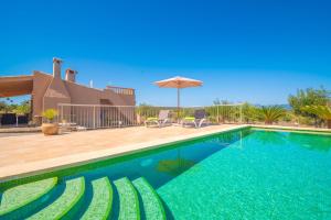a swimming pool in front of a house at Son Morro in Santa Margalida