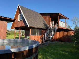 a house with a staircase leading up to it at Diby Kämping Minimajad in Vormsi