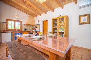 a kitchen with a large wooden table and chairs at Son Morro in Santa Margalida