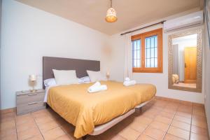 a bedroom with a bed with two towels on it at Son Morro in Santa Margalida