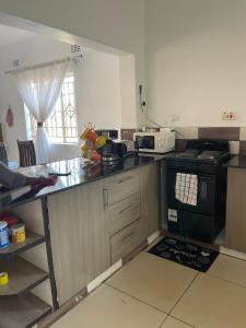 a kitchen with a stove and a counter top at Suzie's Nest 2 in Lilongwe