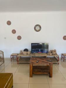 a living room with a table and a tv at Suzie's Nest 2 in Lilongwe