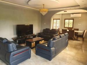 a large living room with couches and a television at villa HALAL in Mfou