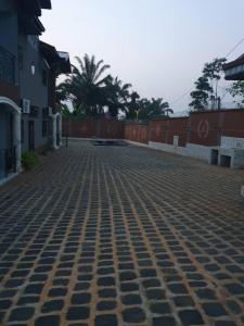 a cobblestone street in front of a building at villa HALAL in Mfou