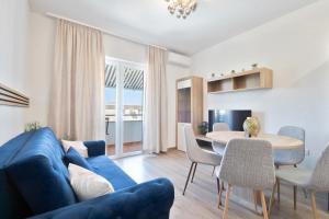 a living room with a blue couch and a table at Apartments Sonja in Tučepi