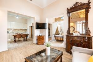 a living room with a large mirror and a table at Absinthia Legacy in Soroni