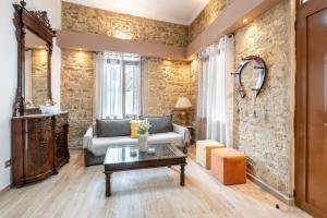 a living room with a couch and a table at Absinthia Legacy in Soroni