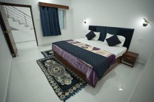 a bedroom with a large bed and a rug at Hotel Parkview in Khajurāho